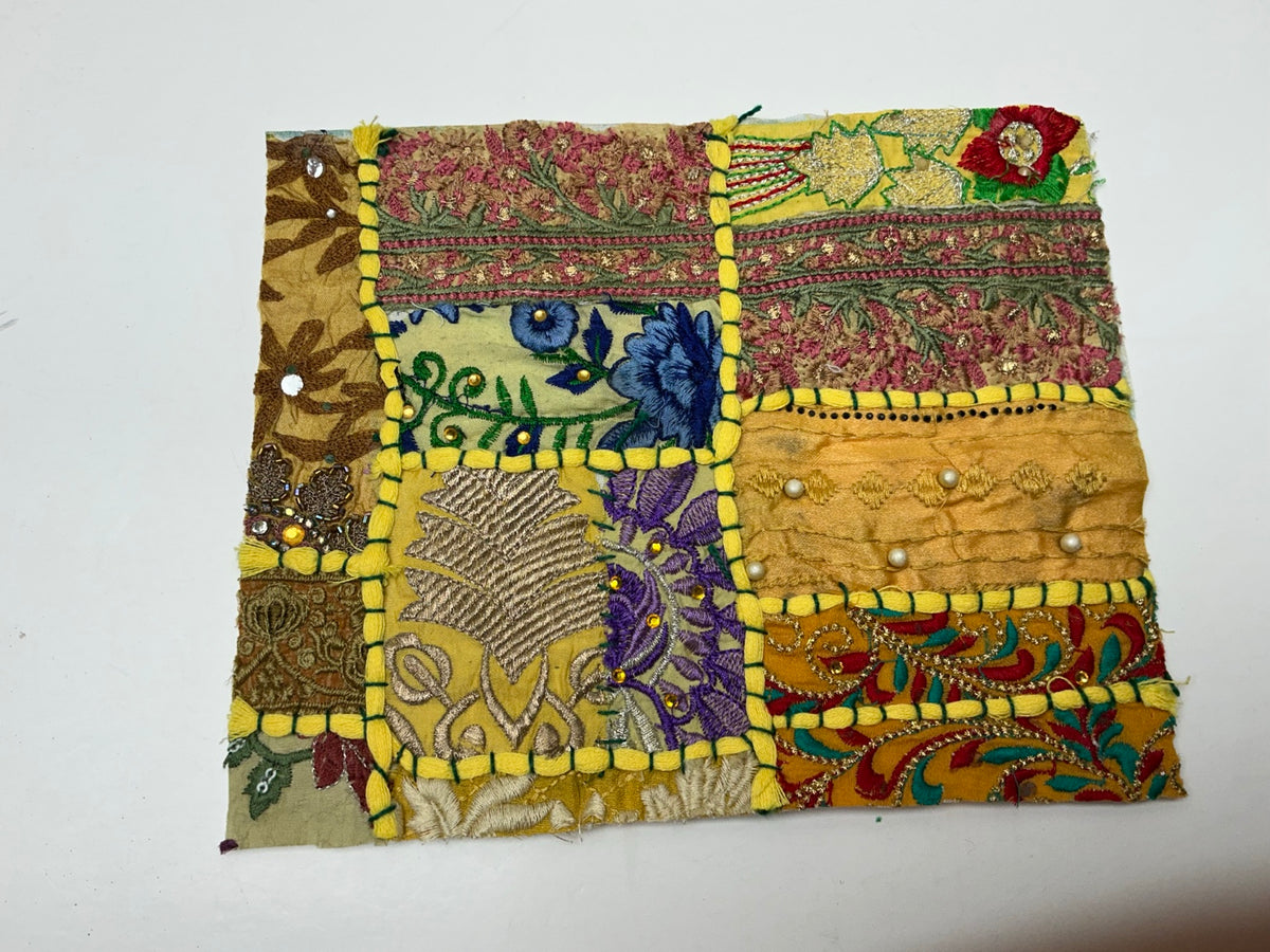 Golden yellow patchwork textile panel with blue purple floral embroidery
