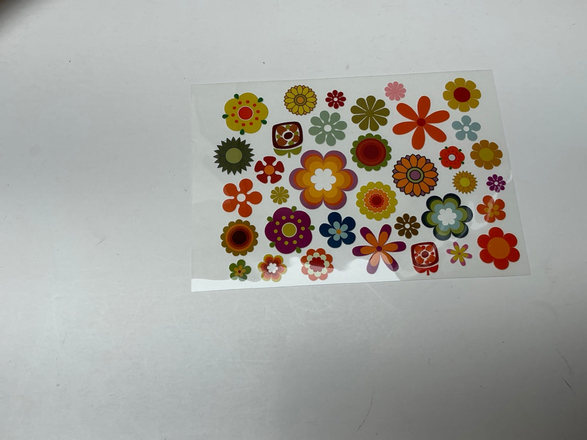 Set of colorful retro flower power embellishments in orange yellow green blue pink and purple